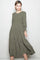 woman wearing an olive green long sleeve smocked midi dress with tiered skirt