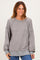 woman wearing a gray ribbed long sleeve sweatshirt with relaxed fit and balloon sleeves