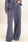 woman wearing navy blue wide leg lounge pants with an elastic waistband and drawstring detail