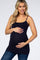 woman wearing a dark navy maternity tank top and holding her baby bump