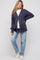 woman wearing a navy blue ribbed maternity cardigan with buttons, paired with a white t-shirt and light blue jeans