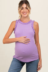 woman wearing a lavender maternity tank top with ruffle details and holding her baby bump