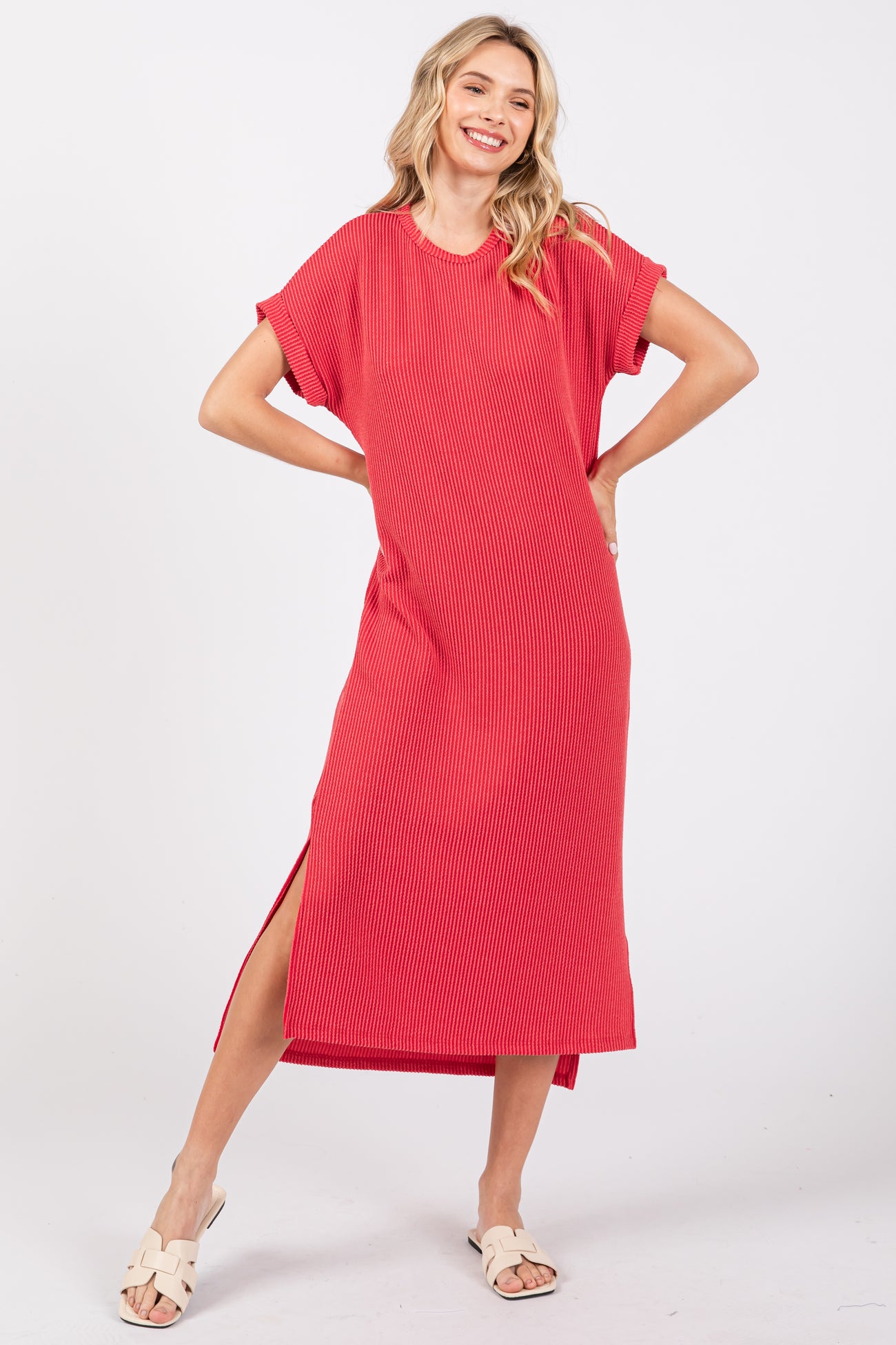 woman wearing a red striped short sleeve maxi dress with side slits and a relaxed fit