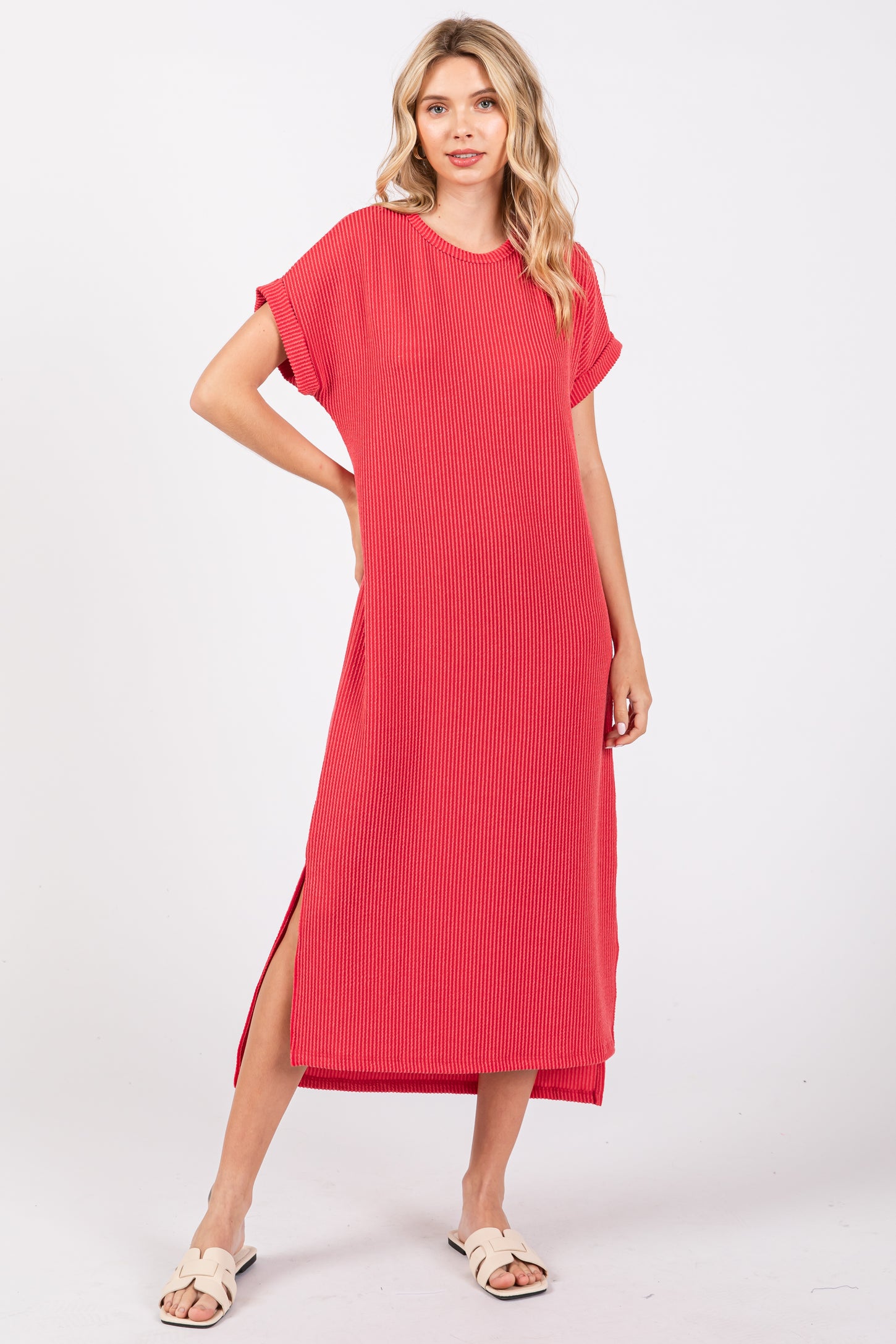 woman wearing a red striped maxi dress with short sleeves and side slits