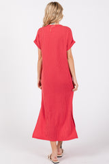 woman wearing a red striped maxi dress with short sleeves and side slits, viewed from the back