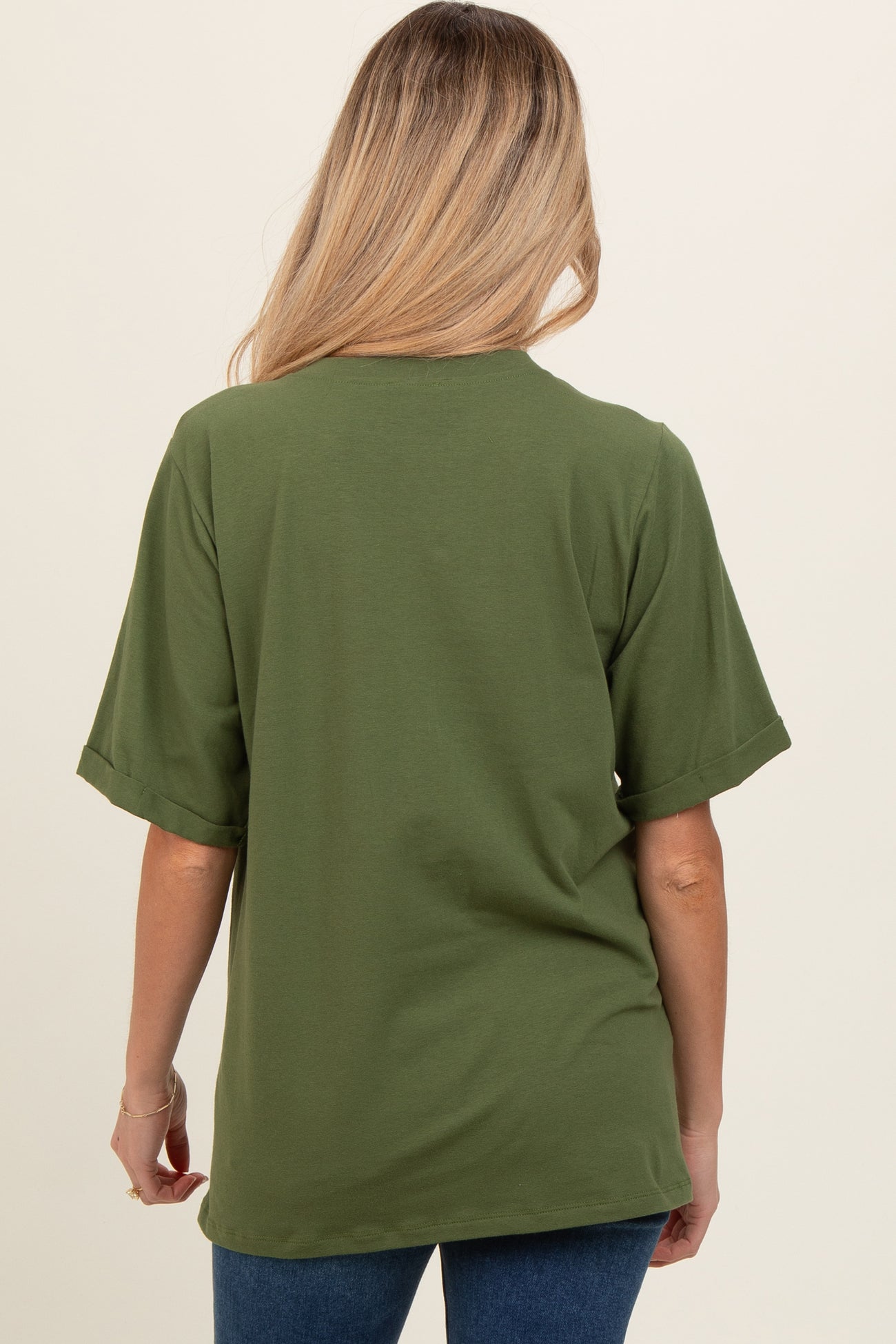 woman wearing a short sleeve olive green maternity top, viewed from the back