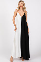 woman wearing a black and white color block maxi dress with a deep v-neck and thin straps