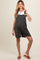 woman wearing a black and white striped maternity romper with a baby bump visible