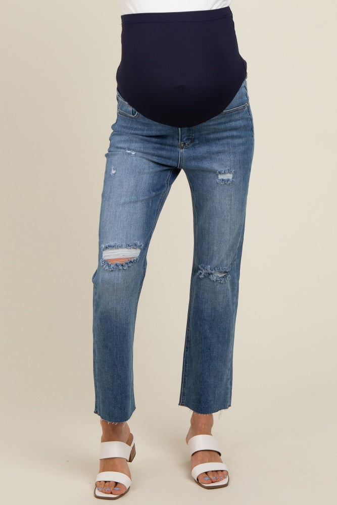woman wearing distressed blue maternity jeans with a navy blue over-the-bump panel