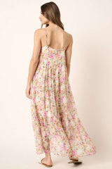 woman wearing a floral maxi dress with spaghetti straps and a flowy skirt, shown from the back