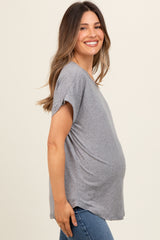 woman wearing a gray short sleeve maternity top and showing her baby bump