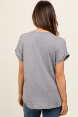 woman wearing a gray short sleeve maternity top with rolled sleeves, showing the back view