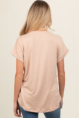 woman wearing a light pink maternity top with short rolled sleeves and a relaxed fit, viewed from the back