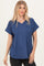 woman wearing a navy blue v-neck short sleeve top with a chest pocket