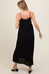 woman wearing a black maternity maxi dress with adjustable straps and a flowy silhouette