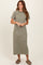 woman wearing a green and cream striped t-shirt midi dress with short sleeves and relaxed fit