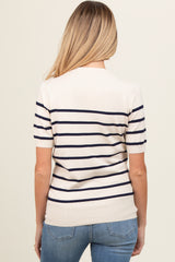 woman wearing a cream and navy striped maternity top, showing a fitted style from the back with short sleeves