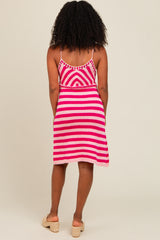 woman wearing a pink and white striped knit sundress with spaghetti straps and a fitted bodice