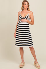 woman wearing a black and white striped maternity dress with spaghetti straps and a baby bump