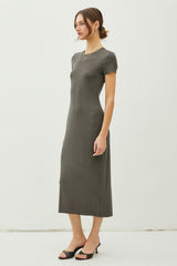 woman wearing a fitted olive green ribbed midi dress with short sleeves and a v-neckline