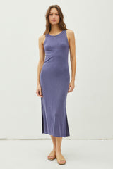woman wearing a purple ribbed midi dress with a side slit and sandals
