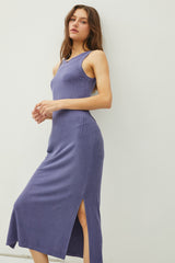 woman wearing a purple midi dress with ribbed texture and side slits
