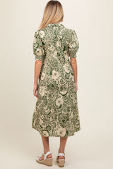 woman wearing a green floral print maternity dress with short puff sleeves, shown from the back