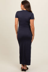 woman wearing a navy blue short sleeve maternity maxi dress from the back
