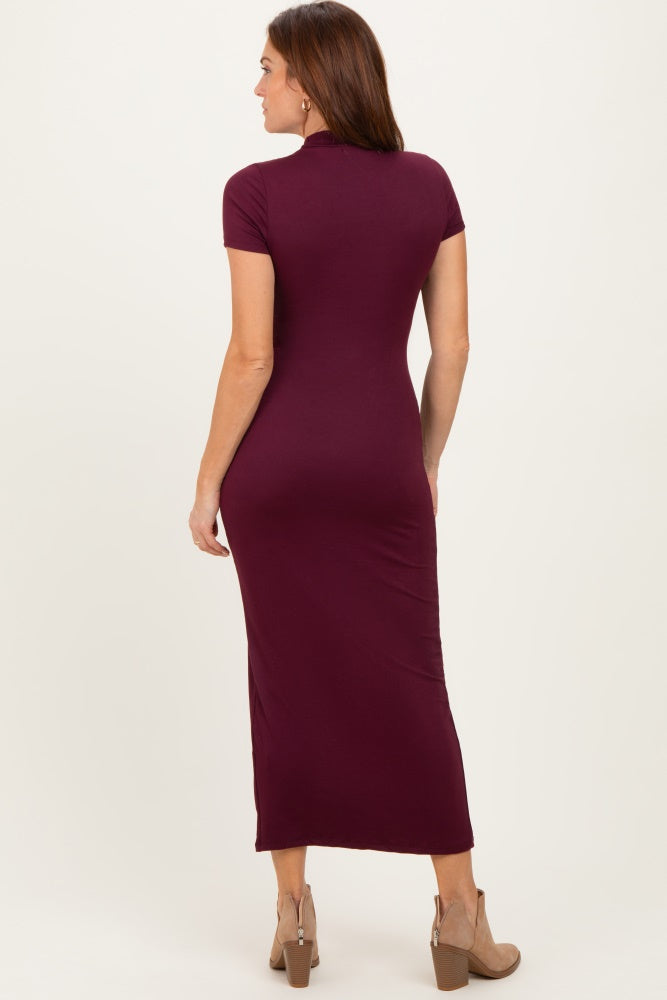 woman wearing a burgundy short sleeve maxi dress, showing the back view and fitted silhouette with a sleek design