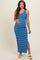 woman wearing a blue and white striped maternity maxi dress, smiling and showing her baby bump