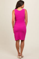 woman wearing a fitted pink ribbed maternity dress, view from the back