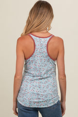 woman wearing a floral print maternity tank top with a racerback style and contrasting straps