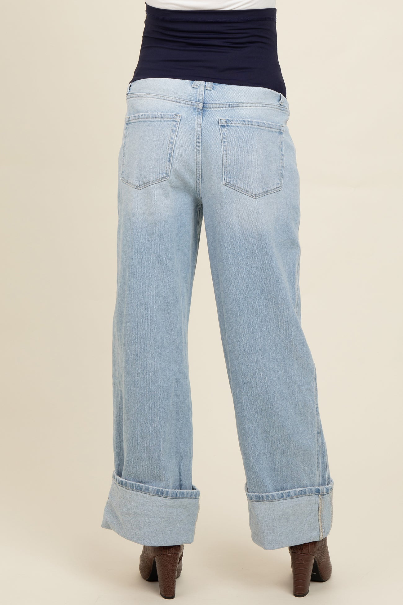 woman wearing light blue maternity wide-leg jeans with a dark blue waistband, viewed from the back