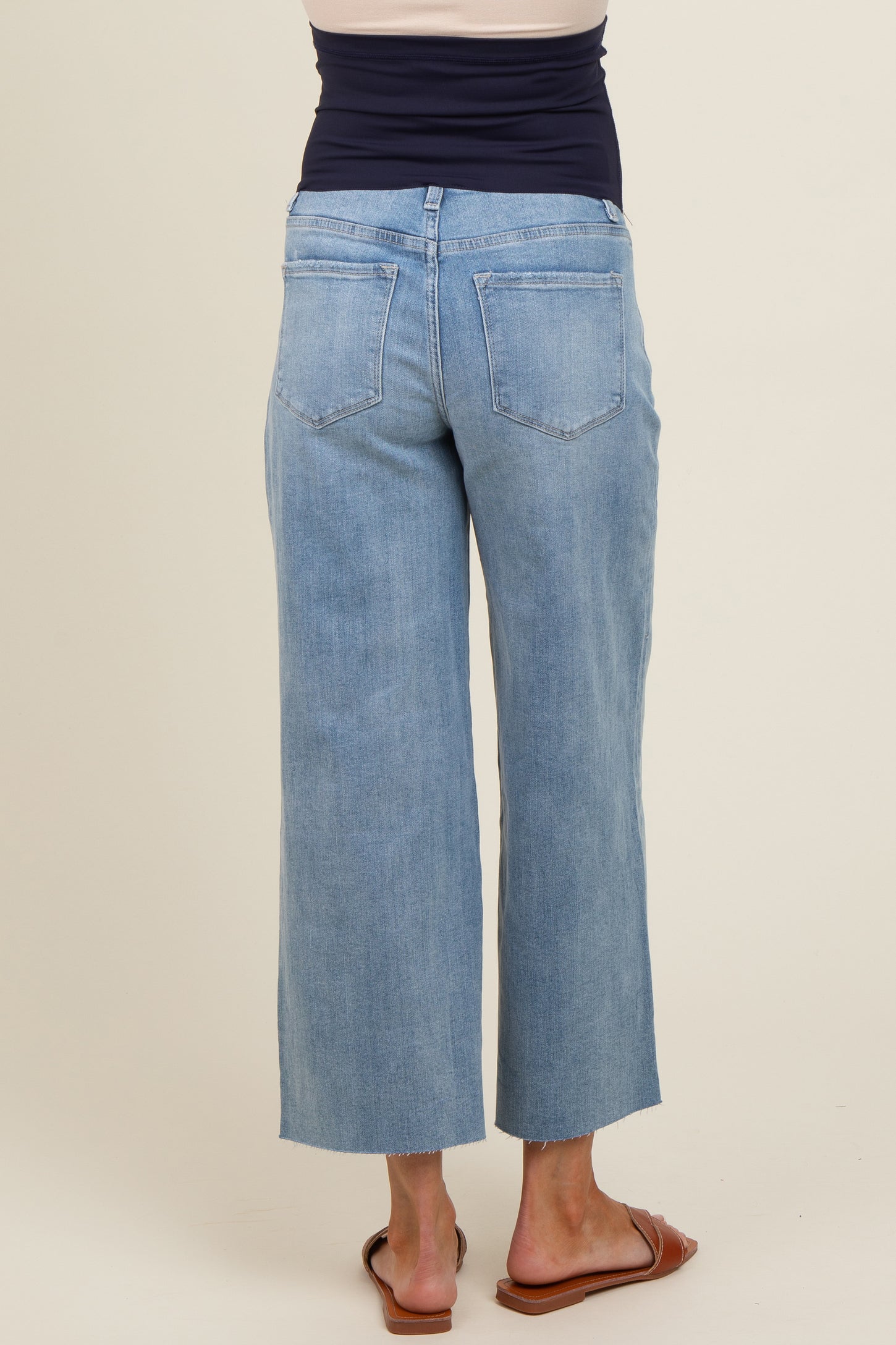 woman wearing light blue wide-leg maternity jeans viewed from the back