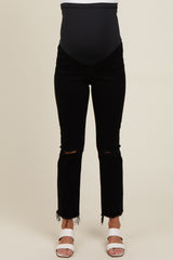 woman wearing black maternity jeans with a belly support band and distressed hem