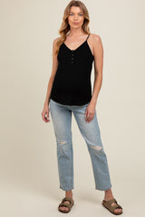 woman wearing a black ribbed maternity tank top with buttons and light blue distressed jeans, showing her baby bump