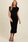 woman wearing a black maternity midi dress with puff sleeves and a visible baby bump