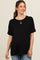 woman wearing a black short sleeve maternity top with rolled cuffs and a baby bump visible