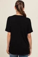 woman wearing a black short sleeve maternity top, shown from the back