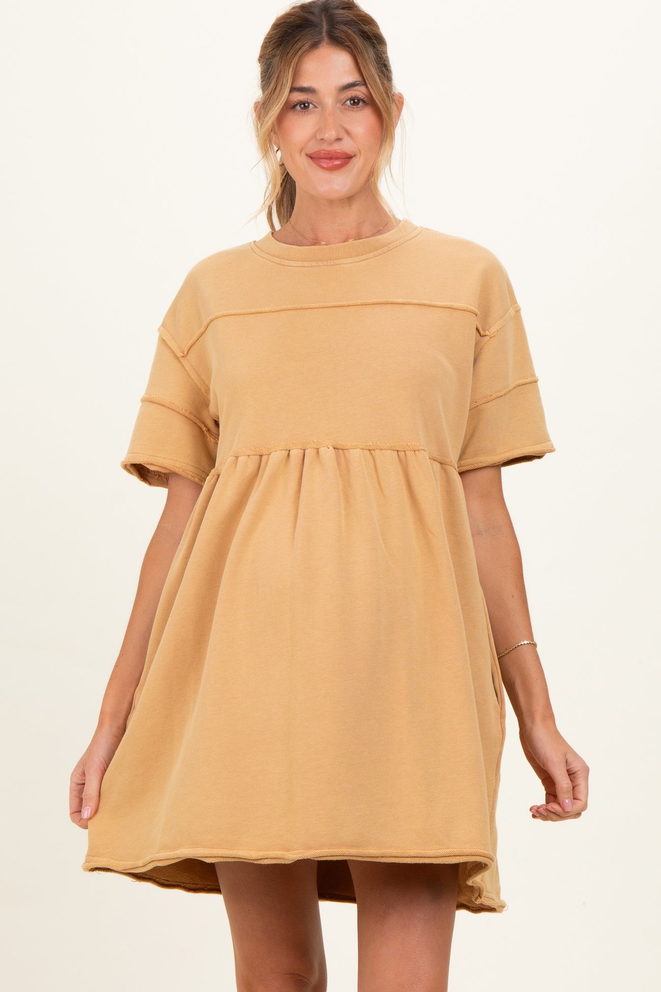 woman wearing a mustard yellow maternity dress with short sleeves and a relaxed fit baby bump visible