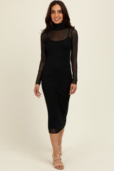 woman wearing a black fitted midi dress with sheer long sleeves and a mock neck, paired with nude heeled sandals
