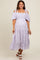 woman wearing a lilac floral cold shoulder maternity dress with puff sleeves and a tiered skirt