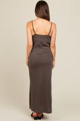 woman wearing a brown spaghetti strap maternity maxi dress, showing a fitted silhouette from the back