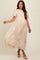 woman wearing a beige lace maternity dress with short sleeves and a flowing skirt, showcasing her baby bump