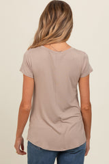 woman wearing a light taupe short sleeve maternity top, shown from the back with a relaxed fit