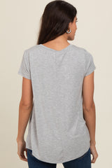 woman wearing a gray short sleeve top with a curved hem and back seam detail