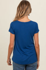 woman wearing a navy blue maternity top, shown from the back, with short sleeves and a relaxed fit