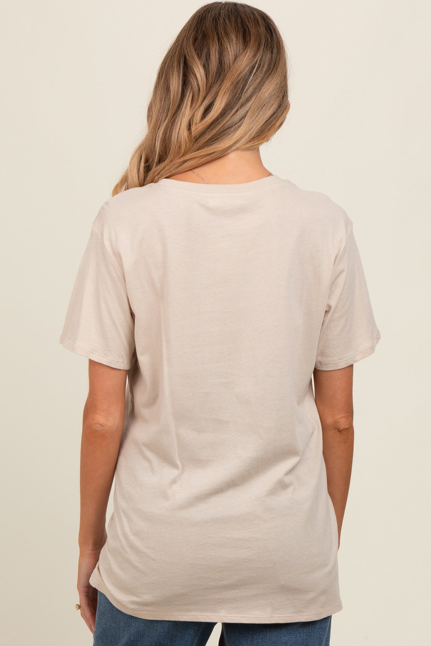 woman wearing a beige short sleeve maternity t-shirt, view from the back