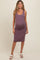 woman wearing a lavender maternity dress with a snug fit, highlighting her baby bump, paired with white sandals