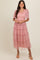 woman wearing a pink tiered tulle dress with puff sleeves and a smocked bodice